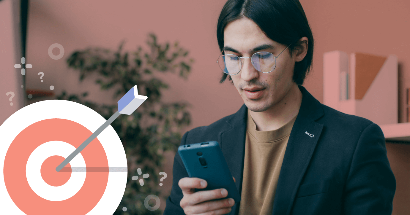 Man looking at phone with icon of a target and an arrow