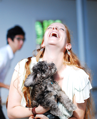 Kimberly Coburn holding a small dog named Luna