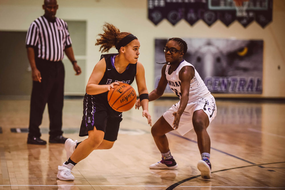 Photo of two women playing basketball