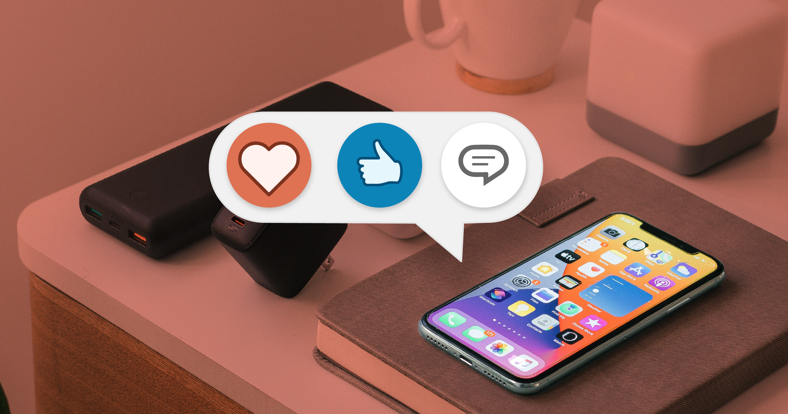 "love" and "like" icons over a mobile phone on a desk