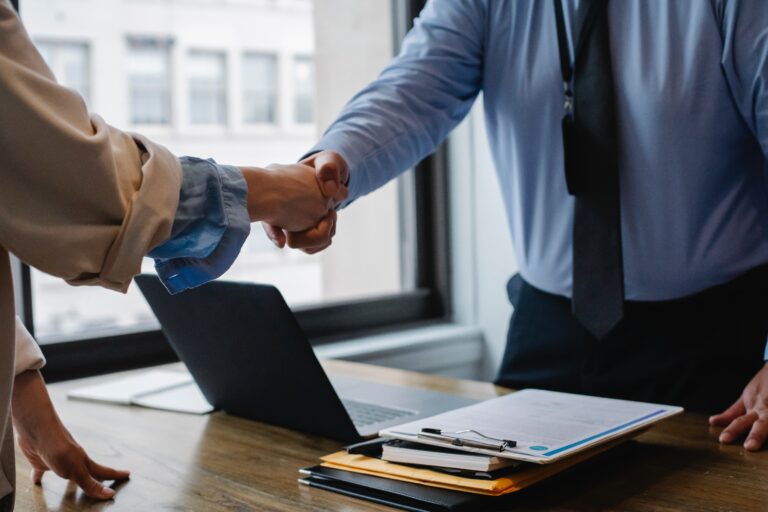 Image of two people shaking hands for a job well done