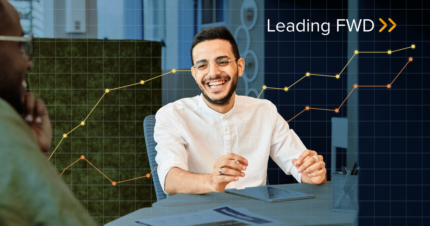 Person smiling in a meeting, discussing marketing trends